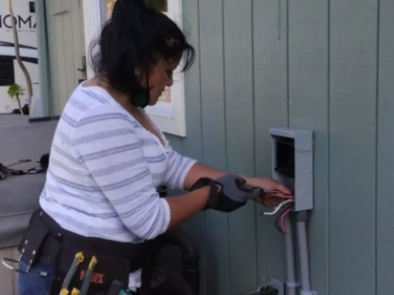 Licensed electrician wiring an exterior subpanel in Argentine